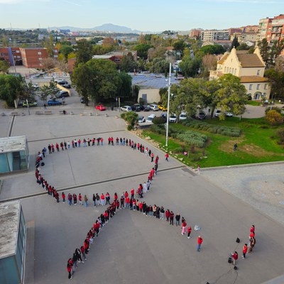 Alumnat de l'Institut Lluís Companys fent un llaç vermell.